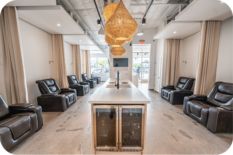 Hydrate IV Bar treatment lounge with leather recliners and woven pendant lighting